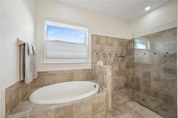 Bathroom featuring tile patterned floors and independent shower and bath