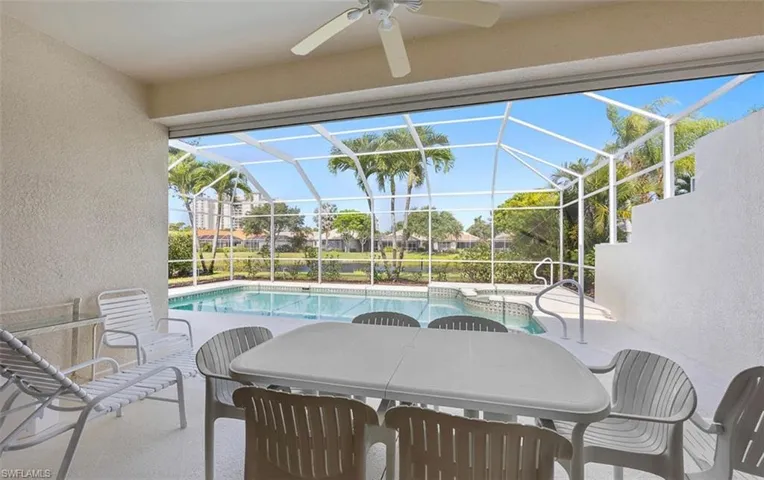 View of pool featuring ceiling fan, a lanai, and a patio area