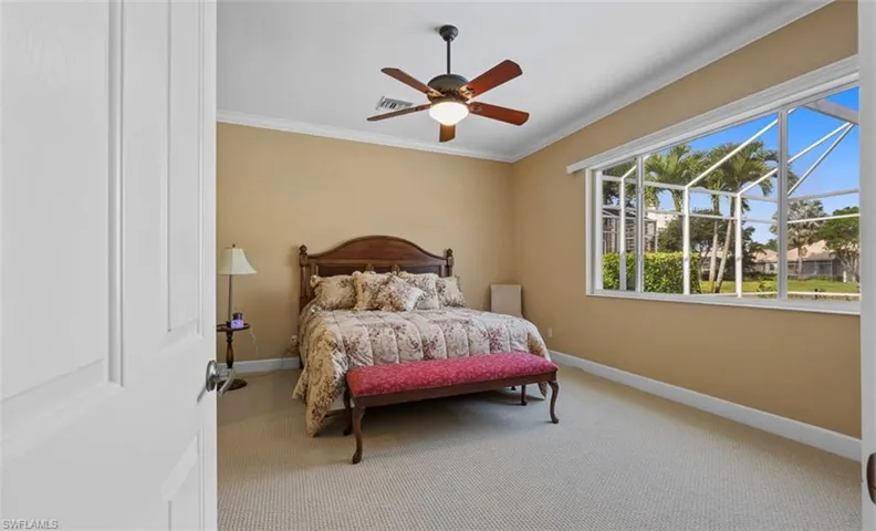 Bedroom featuring ornamental molding, carpet flooring, and ceiling fan