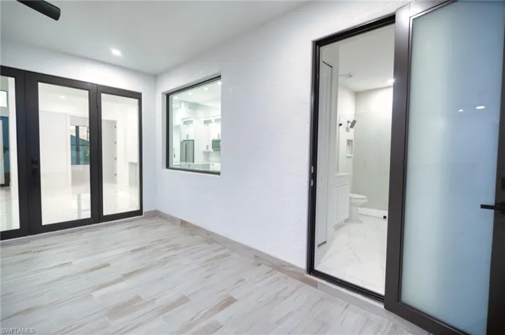 Unfurnished room with a textured wall and light wood-style flooring