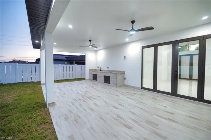 View of patio / terrace with an outdoor kitchen and a ceiling fan
