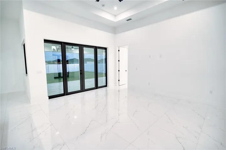Spare room featuring a high ceiling and baseboards