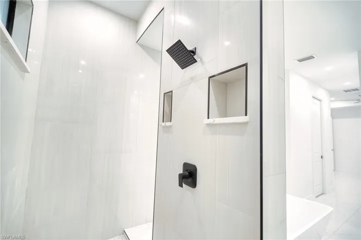Full bath with walk in shower, recessed lighting, and a freestanding bath