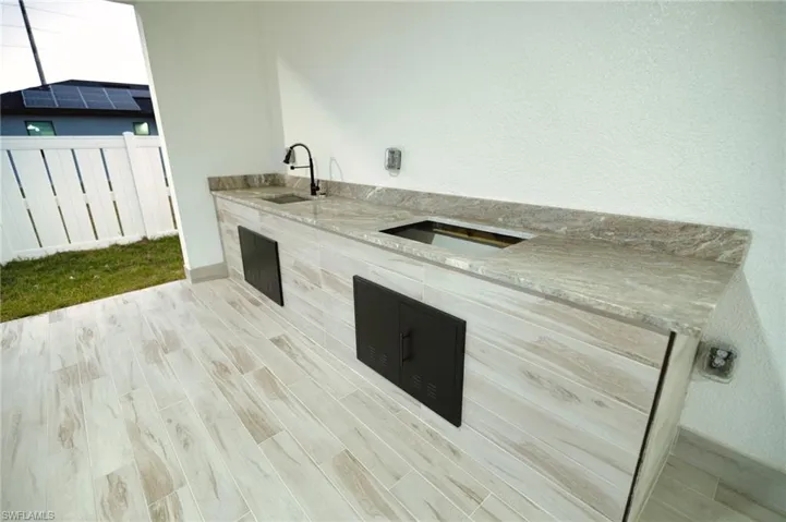 View of patio / terrace featuring a sink and exterior kitchen