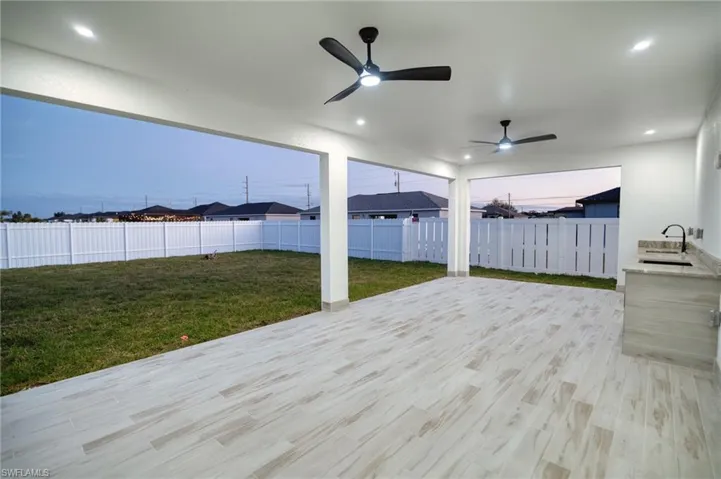 Wooden deck featuring a fenced backyard, a patio area, and ceiling fan