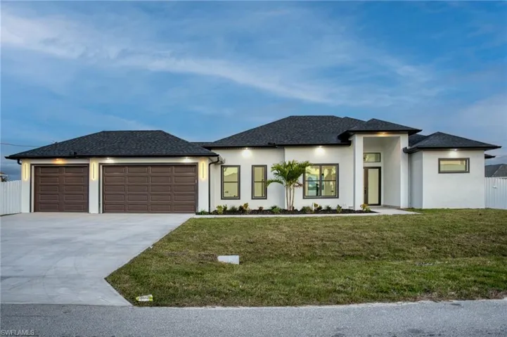 View of front of home with stucco siding, a shingled roof, driveway, and an attached garage