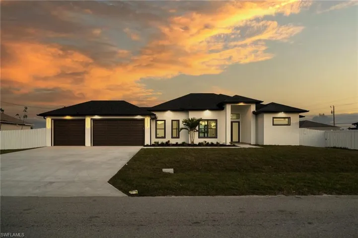 Prairie-style house featuring stucco siding, concrete driveway, and an attached garage