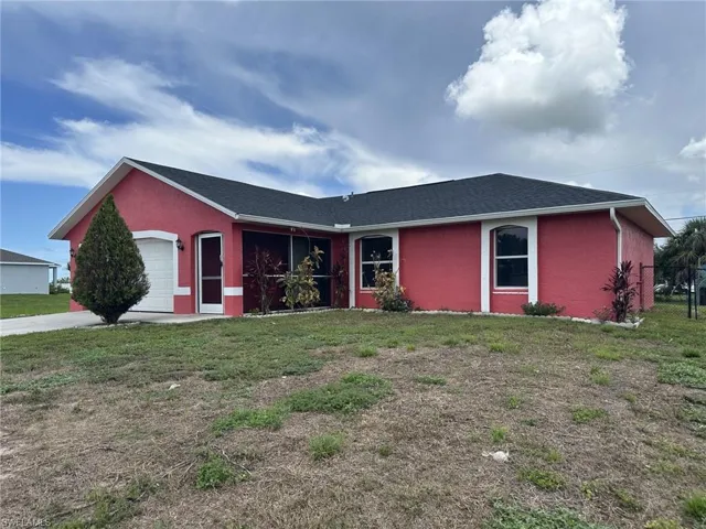 Exterior featuring a vibrant red stucco finish, a black shingle roof, arched garage door, white trim accents, and a screened entry