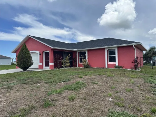 Red stucco exterior with white trim accents and a dark roof
