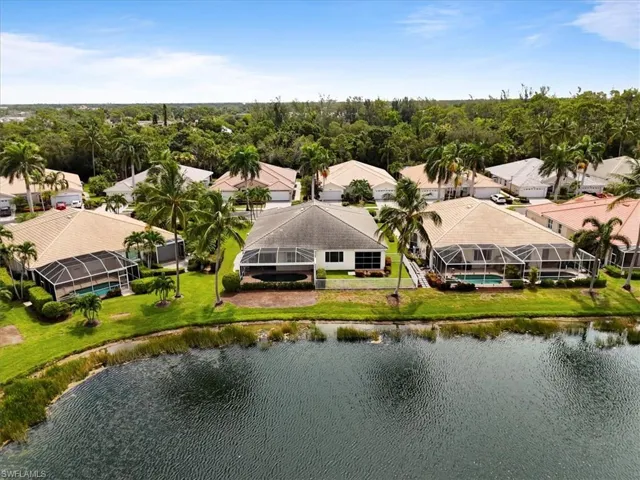 Aerial perspective of suburban area featuring a nearby body of water