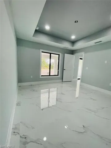 Empty room featuring a raised ceiling