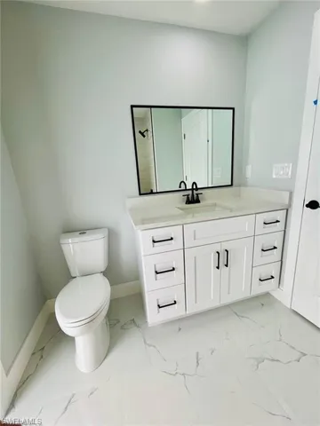 Bathroom featuring vanity and toilet
