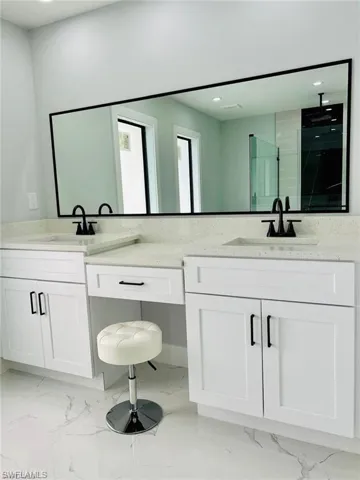 Bathroom featuring vanity and an enclosed shower