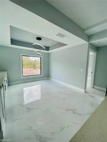 Spare room with a tray ceiling