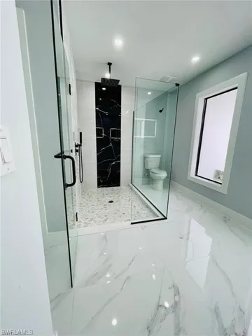 Bathroom with toilet and walk in shower