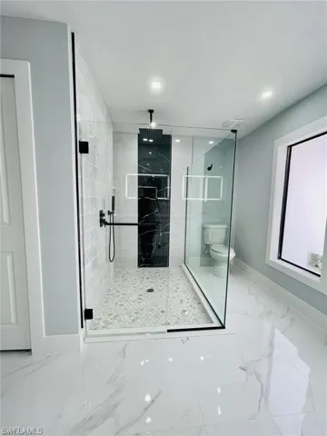 Bathroom with toilet and an enclosed shower