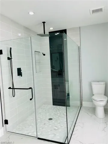 Bathroom featuring toilet and walk in shower