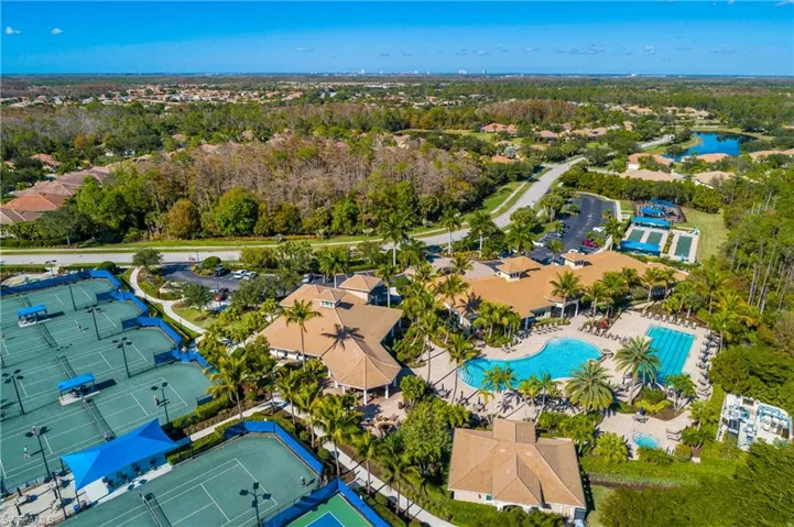 Aerial view of a pool area and a large body of water