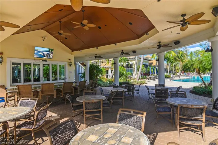 View of patio / terrace featuring outdoor dining space, a ceiling fan, and a community pool