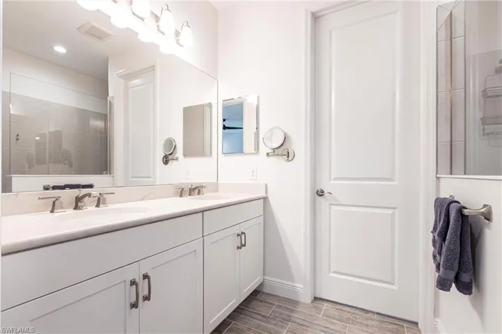 Bathroom featuring vanity and a tile shower