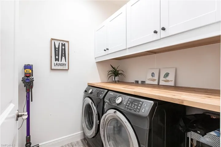 Laundry room featuring cabinets and washer and dryer