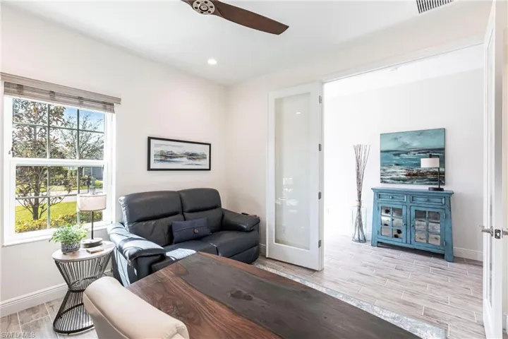 Living room with plenty of natural light and ceiling fan