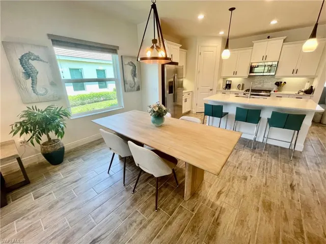 Dining room with recessed lighting, baseboards, and light ceramic wood finished floors