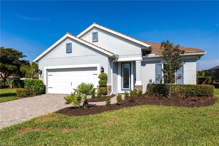 View of front of home with a garage and a front yard