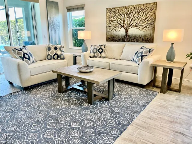 Living area featuring baseboards and tiled floor