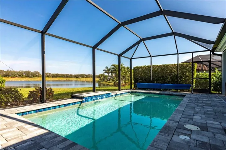 View of pool are from the corner lot of the property overlooking the lake and golf course.