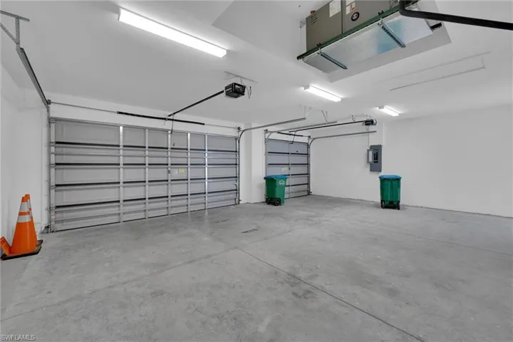 Garage with a garage door opener and electric panel