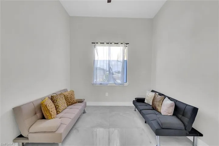 Living room featuring baseboards and marble finish floor