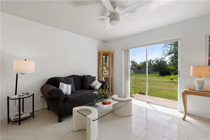 Tiled living room featuring ceiling fan