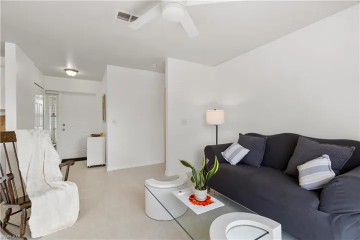 Tiled living room featuring ceiling fan