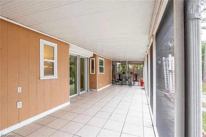 Unfurnished sunroom with wooden walls and tile patterned floors