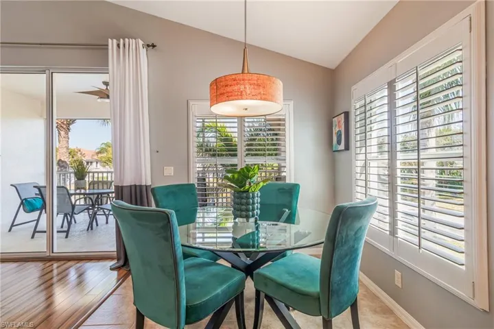 Dining space featuring vaulted ceiling and baseboards