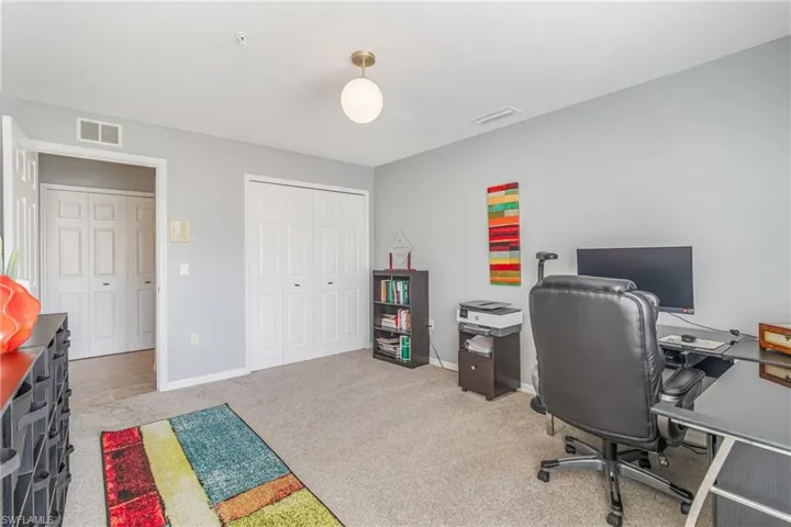 Guest BR Used as an office featuring light carpet and baseboards