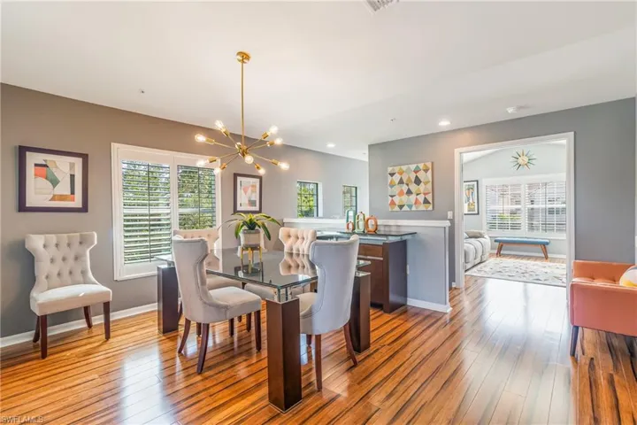 Dining area featuring a chandelier, recessed lighting, and laminate wood-style floors