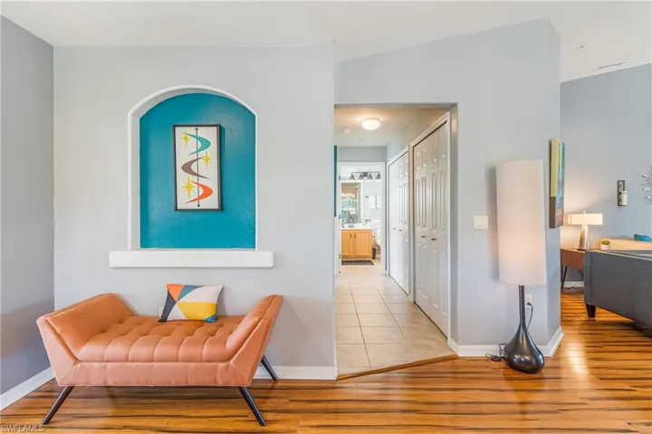 Corridor with light wood-style floors and baseboards