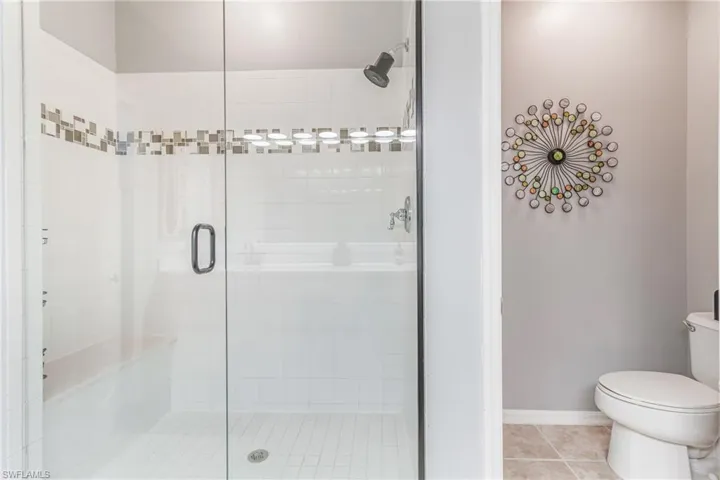 Bathroom featuring a tiled shower and tile patterned floors