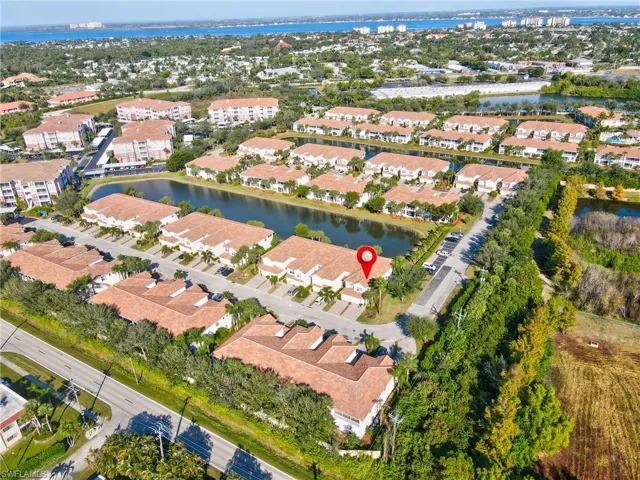 Aerial view of property's location featuring a large body of water and nearby suburban area