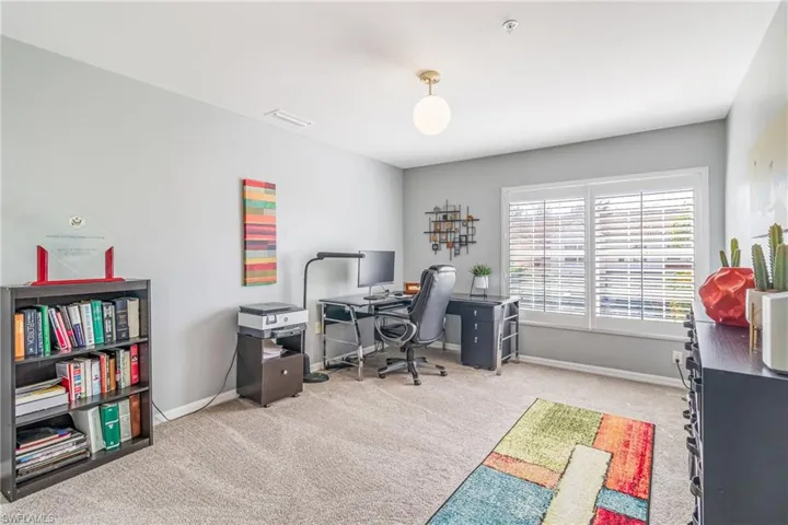 Guest BR Used as an office with light colored carpet and baseboards