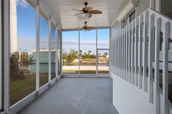Unfurnished sunroom with ceiling fan