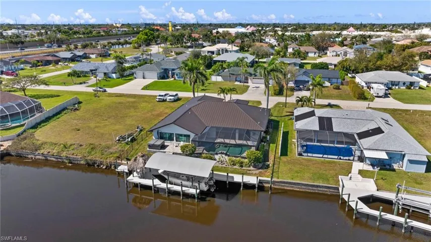 Drone / aerial view with a water view and a residential view
