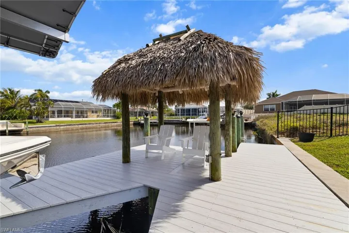Dock area with a residential view and a water view