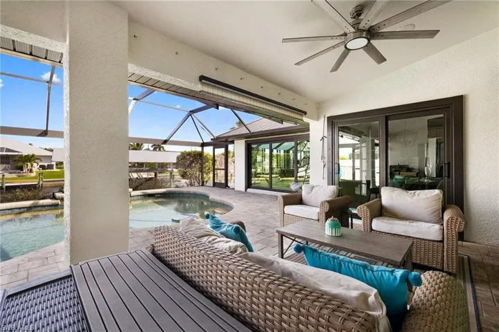 Sunroom featuring vaulted ceiling and a ceiling fan