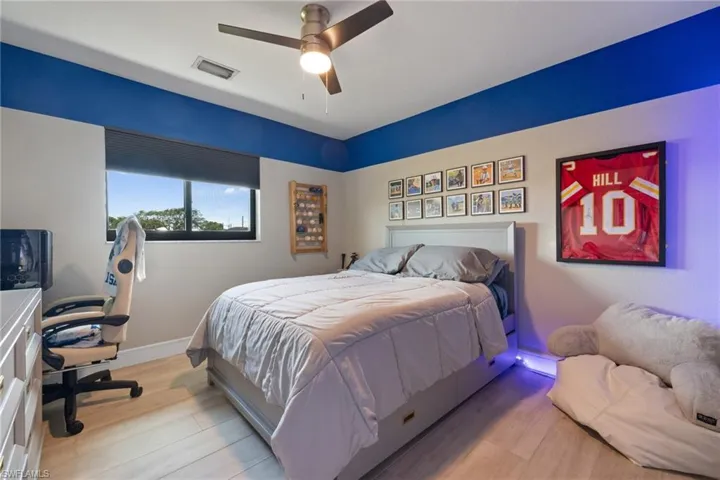 Bedroom with a ceiling fan, baseboards, visible vents, and light wood finished floors