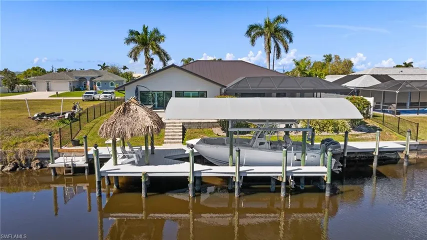 Dock area featuring a water view and a lawn