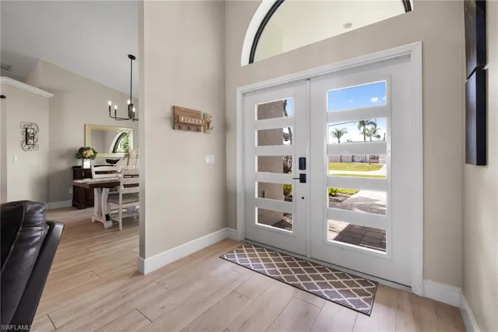 Foyer with french doors, light wood-style flooring, and a wealth of natural light