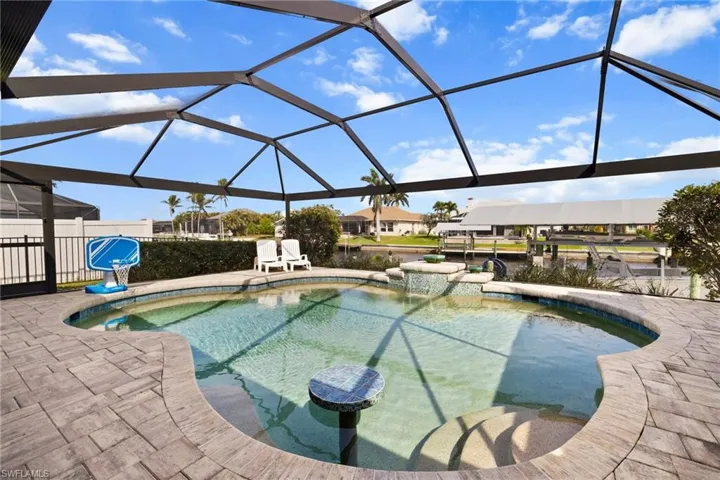 View of pool featuring a patio, glass enclosure, and a fenced in pool